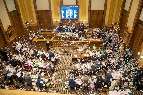 Members of the Georgia Senate throw torn paper in the air following Sine Die, the end of the General Assembly's 40-day legislative session. (Alyssa Pointer / Alyssa.Pointer@ajc.com)