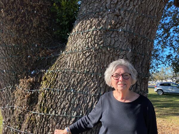 Jan Oliver, 81, in front of the ancient oak tree where members of Hopeful Baptist Church, including Oliver, gather annually for a Christmas celebration. (JOSHUA SHARPE/joshua.sharpe@ajc.com)