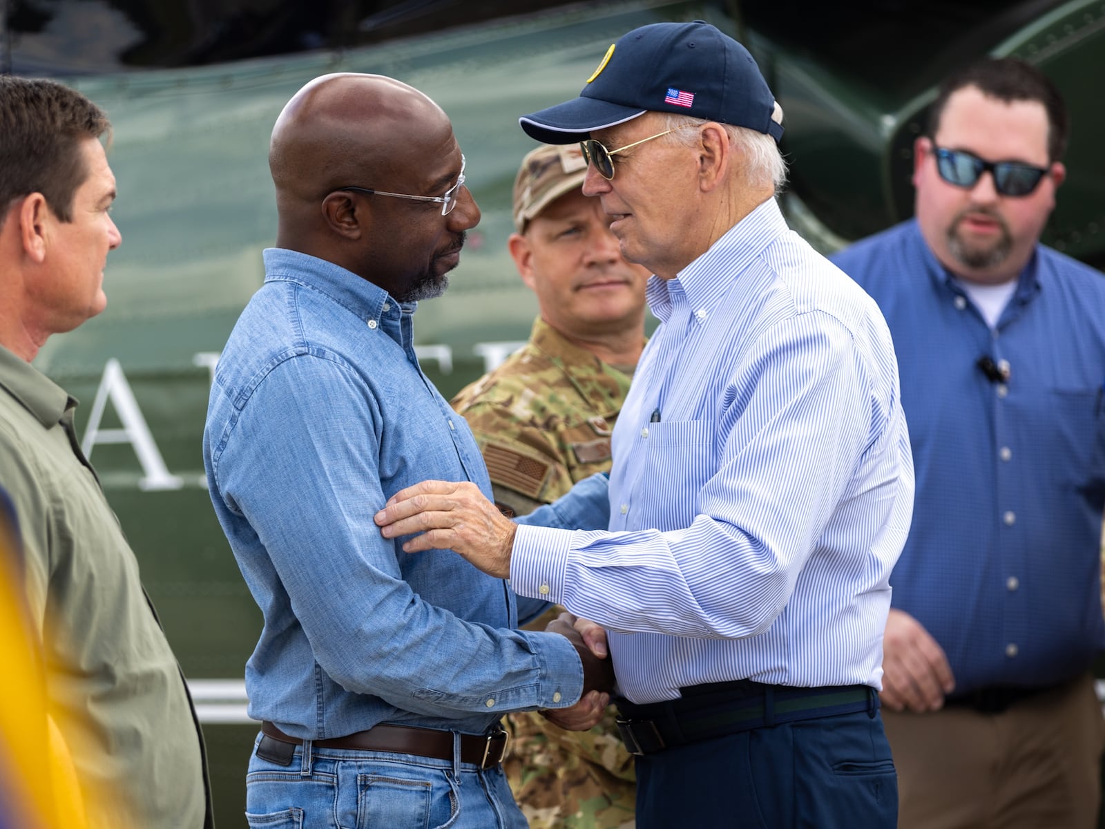 President Joe Biden, right, greets U.S. Sen. Raphael Warnock, D-Ga., on Oct. 3 after leaving Marine One at Moody Air Force Base to tour damage from Hurricane Helene in Ray City. Democrats are now trying to rebuild the coalition that delivered Georgia to Biden in 2020 and propelled Warnock to the Senate in a 2021 runoff. Arvin Temkar/AJC
