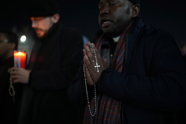 A man holds a rosary beads during a rosary prayer for Pope Francis' health in St. Peter's Square at the Vatican, Tuesday, March 4, 2025. (AP Photo/Alessandra Tarantino)