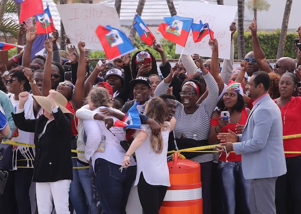 Haitian community members show up in large numbers at the Southern Blvd. bridge in West Palm Beach Monday, January 15, 2018 to protest recent remarks made by President Donald Trump against Haiti. The group said they were there to demand an apology from the President.  Damon Higgins / The Palm Beach Post