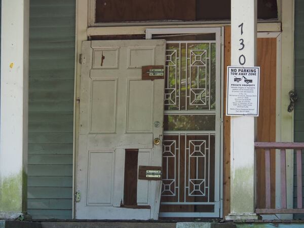 The blue-green house sits on the corner of Dill and Desoto Avenue amid well-kept homes and occasional wayward stragglers. Residents had long complained about the property, which attracted drug-related and violent crime, including the 2016 killing of Vincent Sanders. (Raisa Habersham)