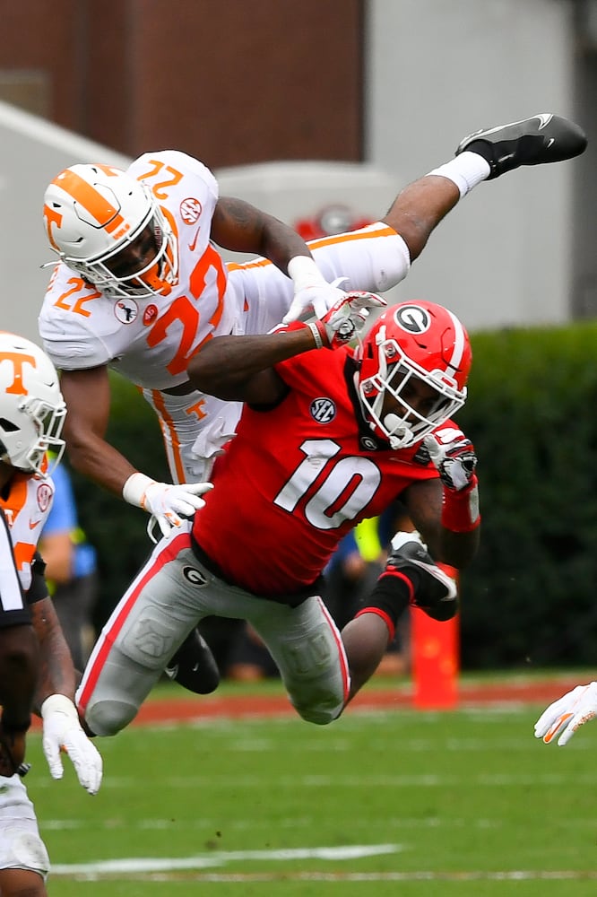 Georgia wide receiver Kearis Jackson (10) gets a pass reception interfeered with by Tennessee defensive back Jaylen McCollough (22)during the first half of a football game Saturday, Oct. 10, 2020, at Sanford Stadium in Athens. JOHN AMIS FOR THE ATLANTA JOURNAL- CONSTITUTION