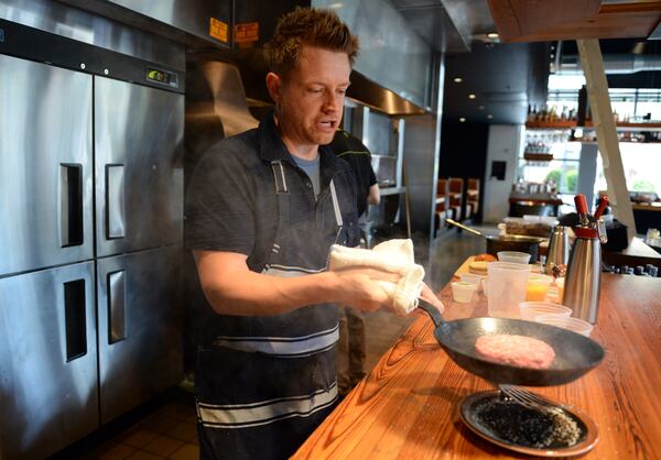 Former executive chef Richard Blais cooks at The Spence in 2013. HYOSUB SHIN / HSHIN@AJC.COM