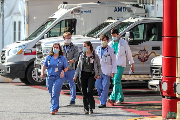 August 9, 2021: Atlanta: Medical workers at Grady Memorial Hospital in Atlanta emerge from the ambulance bay on Tuesday, Aug. 10, 2021 as Hospitals are diverting emergencies because of Covid. Grady Memorial Hospital is only taking Covid patients. COVID-19 cases is hitting Georgia hospitals, igniting concerns of more devastating outbreaks to come. (John Spink / John.Spink@ajc.com)

