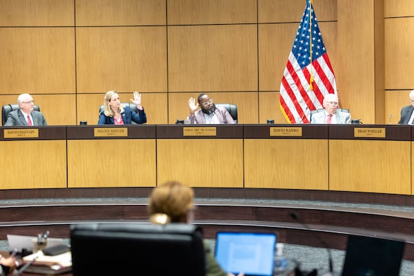 Democrats on the Cobb County school board move to postpone voting on the employment of teacher Katie Rinderle during a school board meeting in Marietta on Thursday, Aug. 17, 2023. The board went on to vote to fire Rinderle, who read a book that challenges gender norms to fifth grade students. (Arvin Temkar / arvin.temkar@ajc.com)