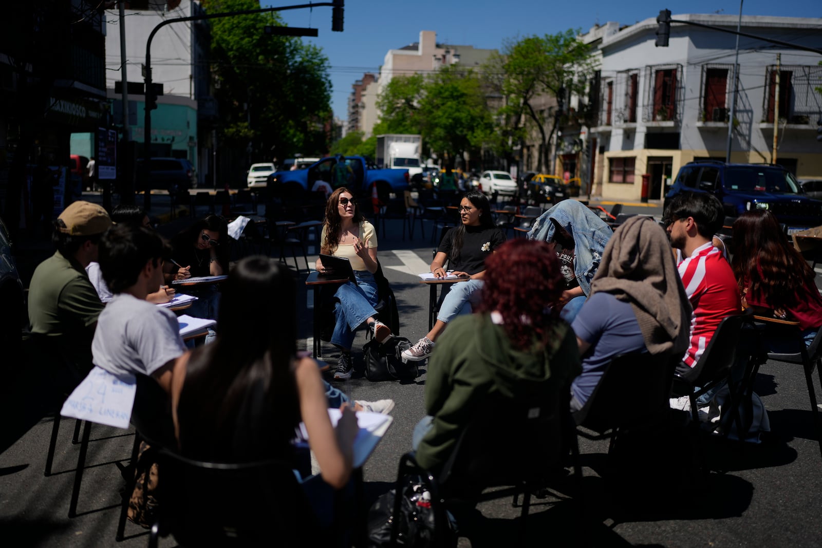 Students hold class in the middle of a street outside the Faculty of Psychology to protest President Javier Milei's veto of higher funding for public universities, in Buenos Aires, Argentina, Wednesday, Oct. 16, 2024. (AP Photo/Natacha Pisarenko)