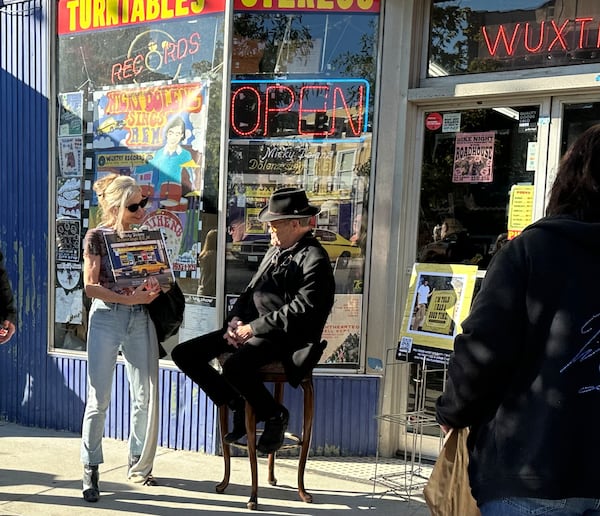 Micky Dolenz meets fans outside Wuxtry Records in Athens Nov. 3, 2023 including Nancy Larson of Avondale Estates, who took time off from work to drive to meet him. RODNEY HO/rho@ajc.com