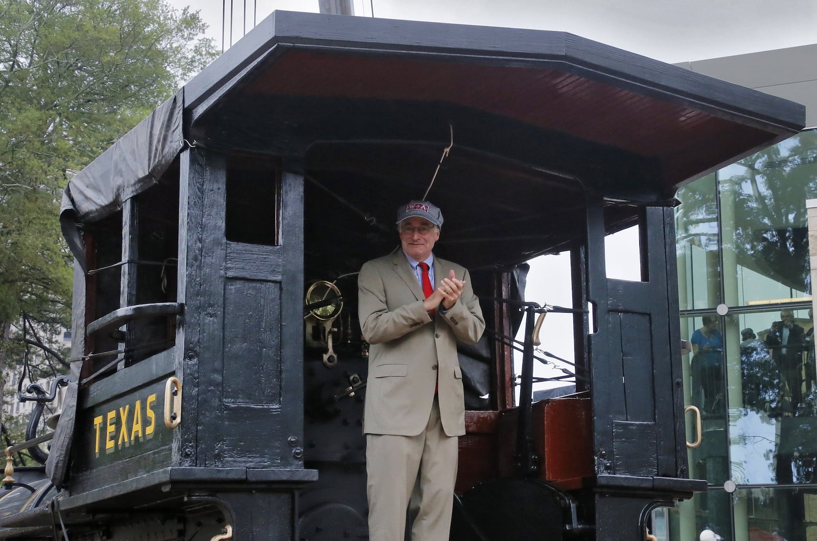 Atlanta History Center President and CEO Sheffield Hale climbed into the cab and applauded as the locomotive Texas arrived at the center Thursday. Hale said, “The Texas locomotive symbolizes Atlanta’s longtime relationship with railroads. … No artifact can be more important for telling the story of Atlanta’s beginnings than this Western & Atlantic locomotive.” BOB ANDRES /BANDRES@AJC.COM