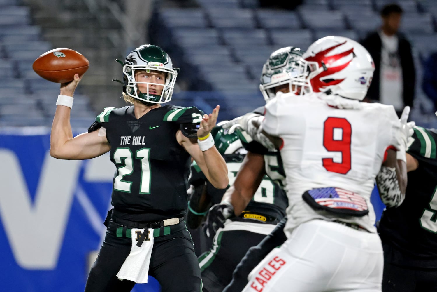 Collins Hill quarterback Sam Horn (21) attempts a pass against Milton during the first half of the Class 7A state title football game at Georgia State Center Parc Stadium Saturday, December 11, 2021, Atlanta. JASON GETZ FOR THE ATLANTA JOURNAL-CONSTITUTION