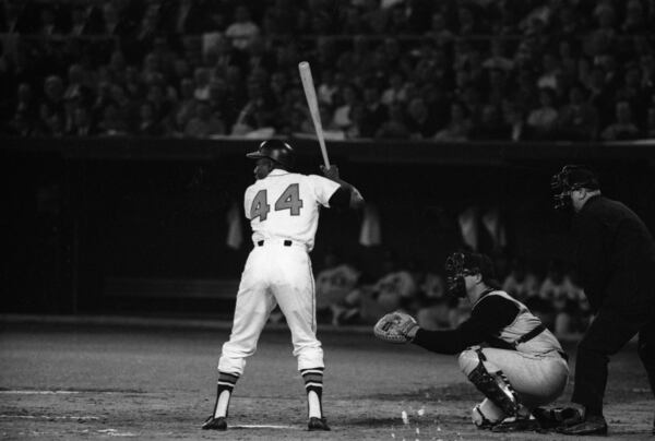 The Braves' Hank Aaron is ready to hammer a pitch during the team's first game in its new home, Atlanta, on April 12, 1966, against the Pittsburgh Pirates. AJC file photo