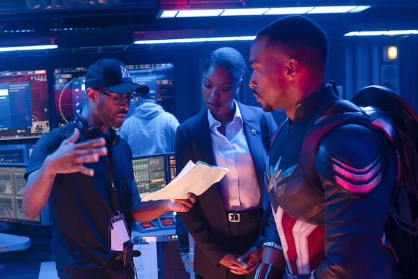 Director Julius Onah (from left), Xosha Roquemore and Anthony Mackie collaborate on the set of Marvel Studios' "Captain America: Brave New World." (Eli Adé/Marvel Studios-Disney via AP)