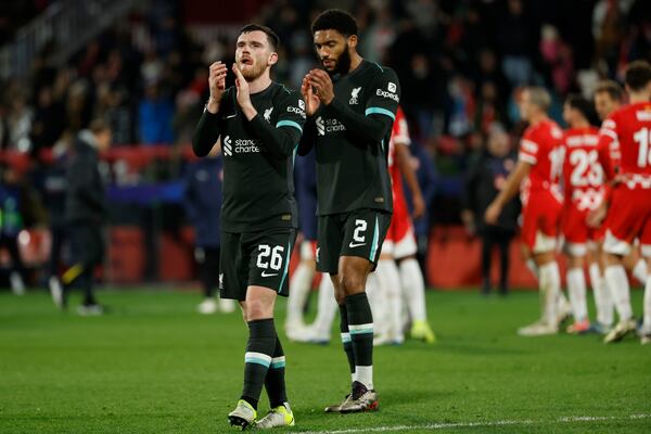 Liverpool's Andy Robertson (left) and Joe Gomez celebrate after their victory in the Champions League soccer match against Girona at Estadi Montilivi in ​​Girona, Spain, Tuesday, December 10, 2024. (AP Photo/Joan Monfort)