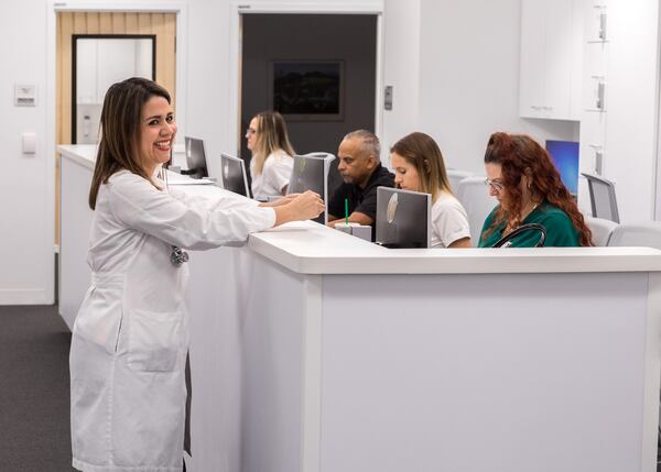 Dr. Jessica Garcia stands near nurses and medical assistants inside Cleveland Clinic Florida’s new Wellington office on Friday. The 7,500-square-foot facility at the intersection of Stribling Way and State Road 7 opens to patients Monday. (Damon Higgins / The Palm Beach Post)