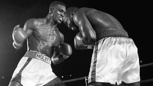 Junior heavyweights Evander Holyfield (left) and Dwight Muhammad Qawi slug it out July 12, 1986, during their WBA title fight in Atlanta.