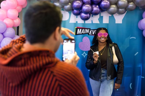 Dhruv Alexander snaps a photo of Myiya Peters at the “Pitch a Friend” dating event on Tuesday, February 11, 2025, at Main Event in Atlanta. Attendees came from across metro Atlanta to pitch their single friends to other singles. CHRISTINA MATACOTTA FOR THE ATLANTA JOURNAL-CONSTITUTION. 