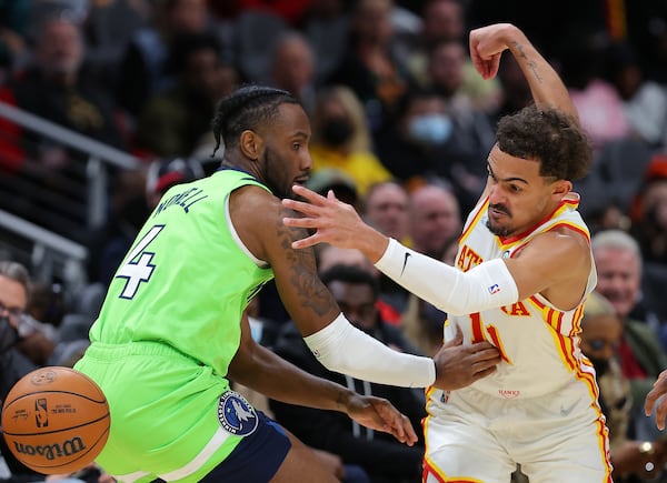 The Atlanta Hawks' Trae Young (11) dribbles through the legs of the Minnesota Timberwolves' Jaylen Nowell (4) on the way to scoring a basket during the second half at State Farm Arena on Wednesday, Jan. 19, 2022, in Atlanta. (Kevin C. Cox/Getty Images/TNS)