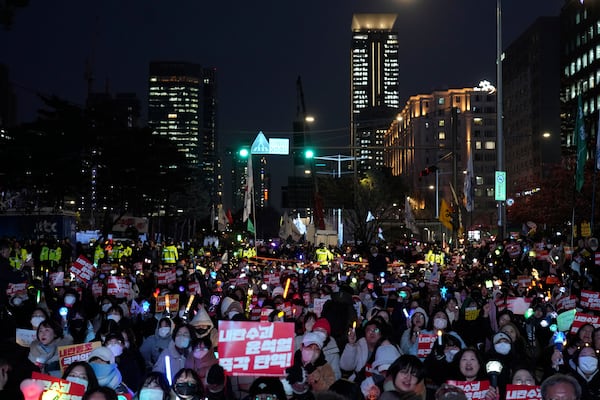 Participants gather to stage a rally demanding South Korean President Yoon Suk Yeol's impeachment, in front of the headquarters of the ruling People Power Party in Seoul, South Korea, Tuesday, Dec. 10, 2024. The banners read "Immediately impeachment Yoon Suk Yeol." (AP Photo/Lee Jin-man)