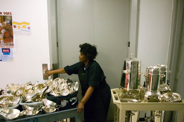  Barbara Jackson, the silver room attendant at the Ritz-Carlton, Buckhead, uses an elevator while taking items to the cleaning room on Wednesday night, Dec. 10, 2008. The mother of six grown children works the overnight shift, helping to ensure that thousands of silver items reflect the hotel's high standards. ALLEN SULLIVAN / aesullivan@ajc.com