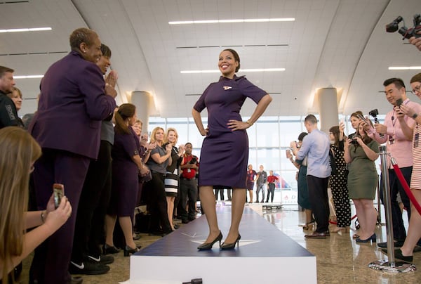 A Delta employee poses for photographs in her new uniform during the Delta Uniform launch at the International Terminal lobby in Atlanta GA Tuesday, May 29, 2018. STEVE SCHAEFER / SPECIAL TO THE AJC