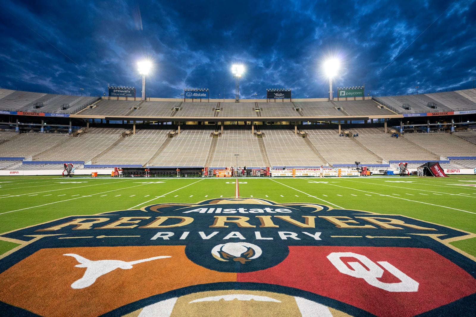 FILE - The logos of Texas and Oklahoma are painted at midfield before an NCAA college football game at the Cotton Bowl, Saturday, Oct. 7, 2023, in Dallas. (AP Photo/Jeffrey McWhorter, File)