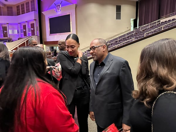 Frank Ski and Nina Brown greet mourners after the homegoing ceremony for Wanda Smith. Ski worked together with Smith for many years as morning hosts on V-103. (Rodney Ho/AJC)