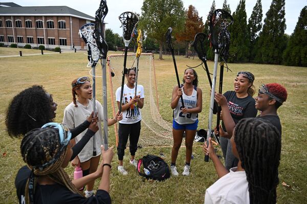 October 25, 2022 Atlanta - Members of Spelman Lacrosse team, clockwise from left, Kaitlin Britton Wheeler (midfielder), Laila Christian (goalie), Kyle Irwin (midfielder), Sedera Green (defender), Olivia Robinson (midfielder), Deanna Lindo (midfielder), Jamea Beavens (defender) and Natajha Graham (midfielder) cheer as they end their practice at Spelman College on Tuesday, October 25, 2022. (Hyosub Shin / Hyosub.Shin@ajc.com)