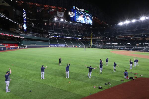 Braves pitchers loosen up during the team workout Sunday, Oct. 11, 2020, ahead of the best-of-seven National League Championship Series against the Los Angeles Dodgers under a open roof at Globe Life Field in Arlington, Texas. (Curtis Compton / Curtis.Compton@ajc.com)