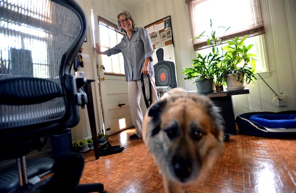 Amanda Kyle Williams prepares to go out to her backyard with her dog Brando in Decatur. HYOSUB SHIN / HSHIN@AJC.COM