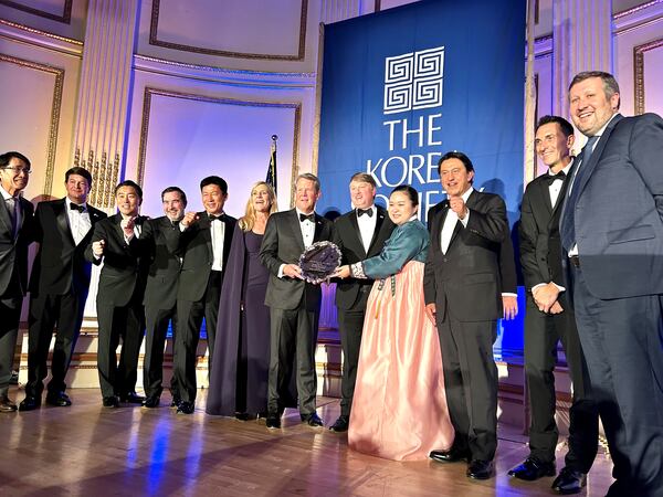 Gov. Brian Kemp, center, is joined by officials from the state, Hyundai Motor Group and other business and diplomatic officials at the annual Korea Society dinner. The state was honored with the Gen. James A. Van Fleet Award for its economic alliance with Korea. (J. Scott Trubey/AJC)