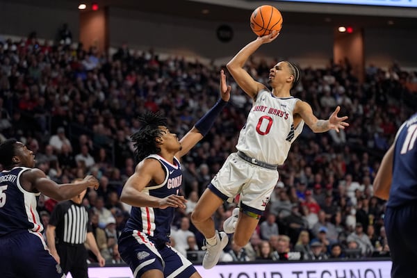 Saint Mary's guard Mikey Lewis (0) shoots over Gonzaga guard Michael Ajayi (1) during the first half of an NCAA college basketball championship game in the West Coast Conference men's tournament Tuesday, March 11, 2025, in Las Vegas. (AP Photo/John Locher)