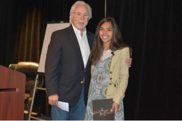 Hannah Testa (right) of Cumming was awarded with the Pioneer of Sustainability award from Ted’s Montana Grill CEO, George McKerrow (left) at the restaurant’s 2016 annual conference.