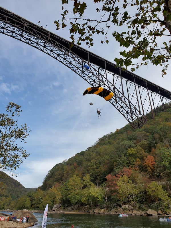 An annual event features jumpers parachuting 876 feet from the New River Gorge Bridge, the longest steel arch span in the Western Hemisphere, to the water at the bottom of the scenic canyon in West Virginia. MUST CREDIT: Bridge Day