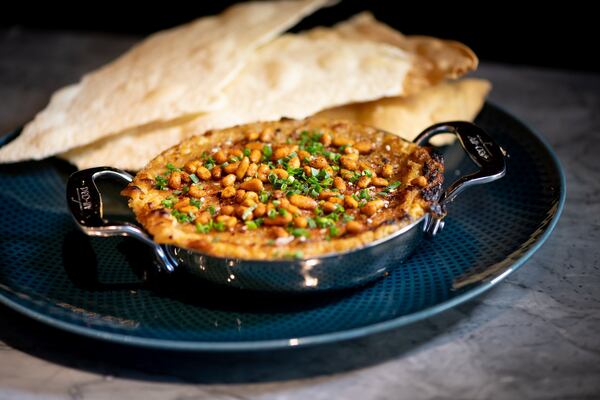 Wood-Fired Hummus with charred sweet onion, toasted pine nut, and lavash cracker. Photo credit- Mia Yakel.