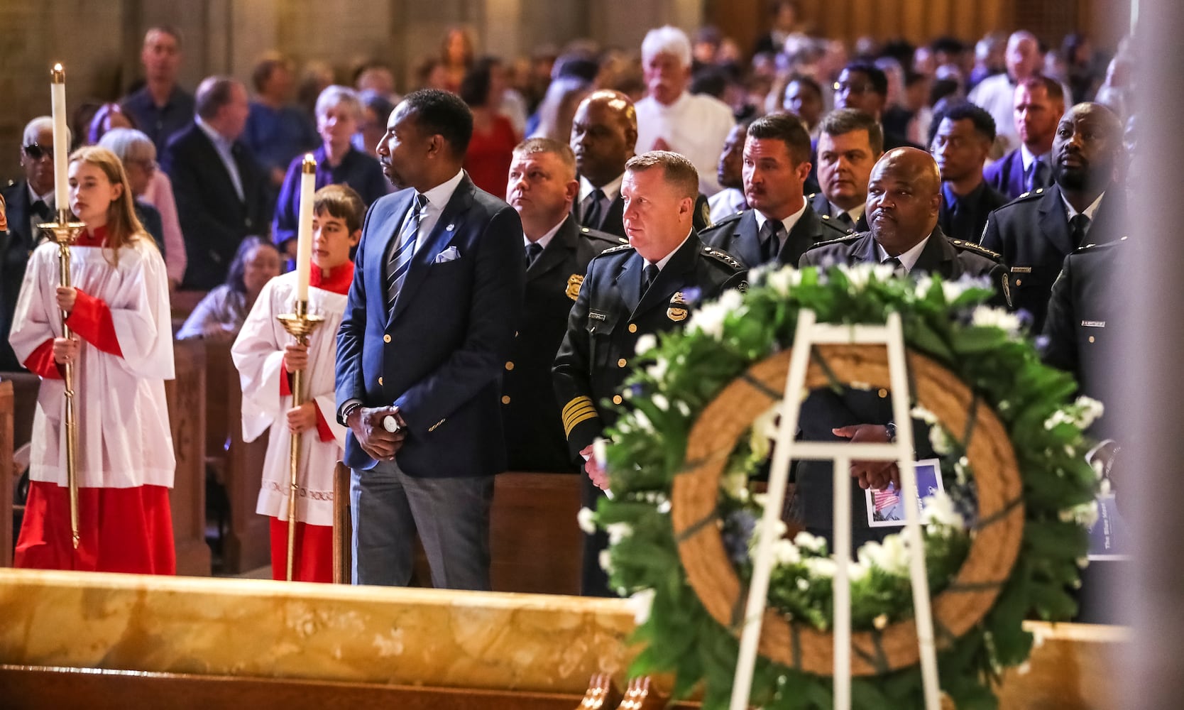 September 11, 2023 Atlanta: Atlanta Mayor Andre Dickens (left-center) watches the procession of altar servers come forward at the beginning of Mass as Atlanta police Chief Darin Schierbaum (center) looks on. Atlanta police and firefighters were in attendance on Monday, September 11, 2023 at the Cathedral of Christ the King, 2699 Peachtree Road, NE in Buckhead in observance of the Blue Mass. The annual Mass honors public safety officials and first responders. City of Atlanta Mayor, Andre Dickens, along with police, fire officials and honor guards participated in the solemn Mass led by Rector, Monsignor Francis G. McNamee. Wreaths were posted in front of the of the church, honoring those who lost their lives on Sept. 11, 2001. The Blue Mass tradition began in 1934, when a priest from the Archdiocese of Baltimore, Father Thomas Dade formed the Catholic Police and Firemen’s Society. (John Spink / John.Spink@ajc.com)

