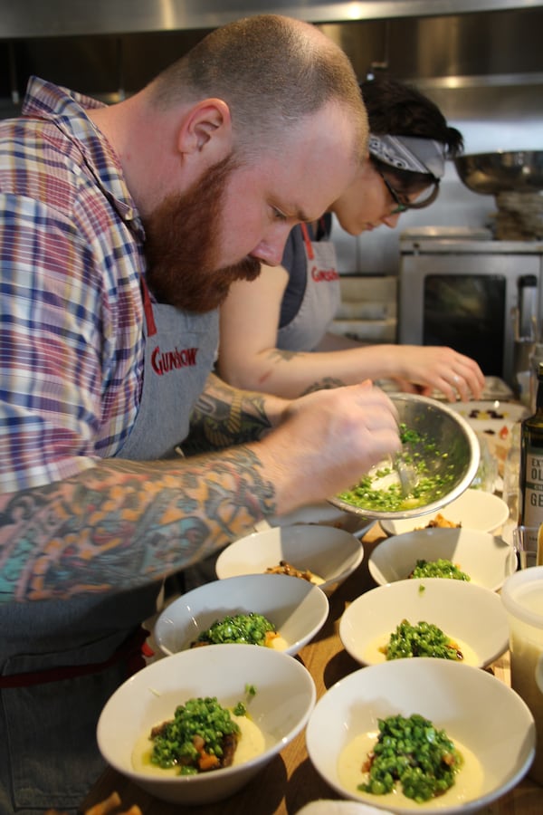 Kevin Gillespie plates food at his Glenwood Park restaurant Gunshow.  “The founding principle of Gunshow was rooted in the interaction of the cooks with the guests," Gillespie said. "So really, everything we do is tableside.” / Courtesy of Gunshow