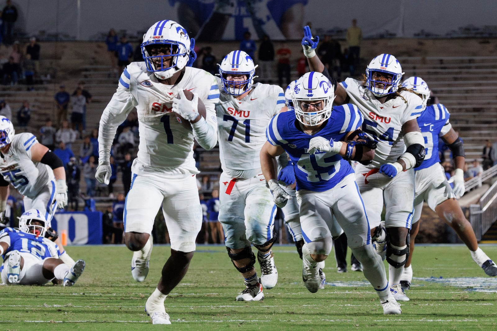 SMU's Brashard Smith (1) carries the ball for a touchdown to take the lead in overtime during an NCAA college football game against Duke in Durham, N.C., Saturday, Oct. 26, 2024. (AP Photo/Ben McKeown)