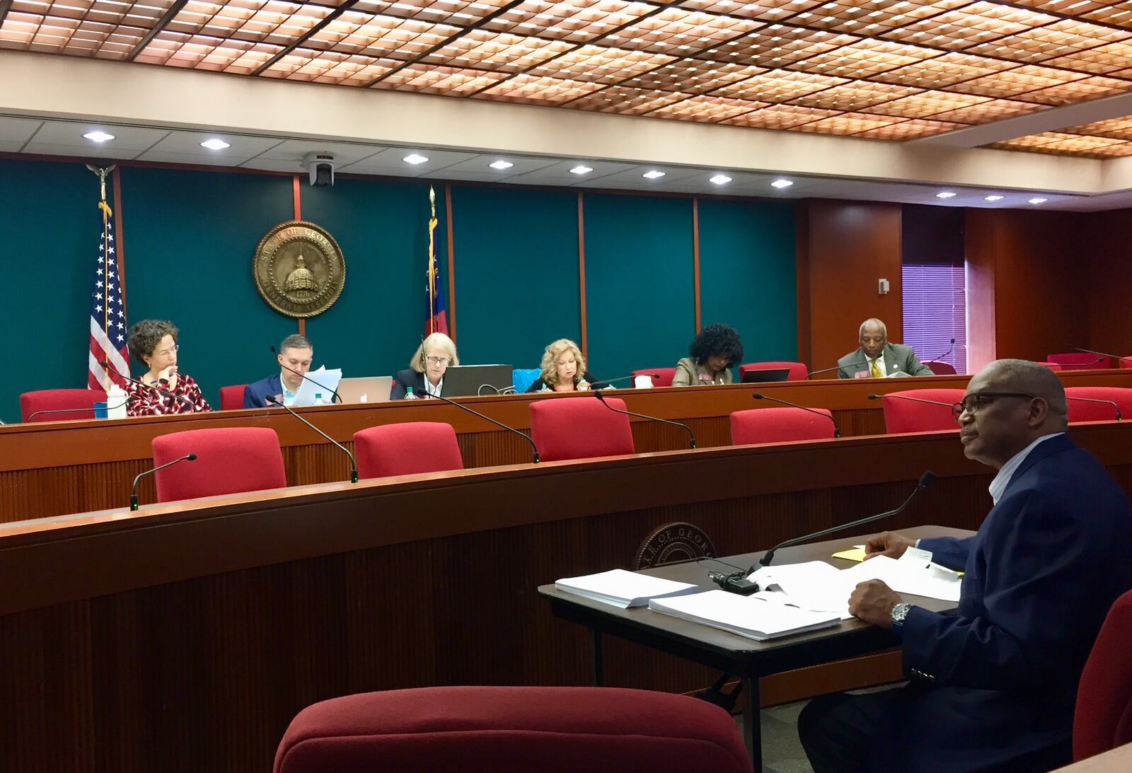 Sen. Emanuel Jones (right) speaks before the DeKalb House delegation about the ethics bill in March. (Photo: J.D. Capelouto/jdcapelouto@ajc.com)