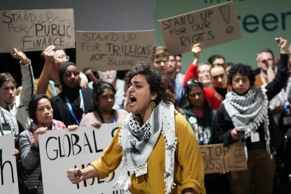 Activists participate in a demonstration for climate finance at the COP29 U.N. Climate Summit, Saturday, Nov. 23, 2024, in Baku, Azerbaijan. (AP Photo/Sergei Grits)