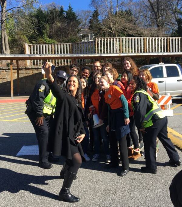 Atlanta Public Shools Superintendent Meria Carstarphen takes a selfie with school resource officers and students who planned the Inman Middle walkout.