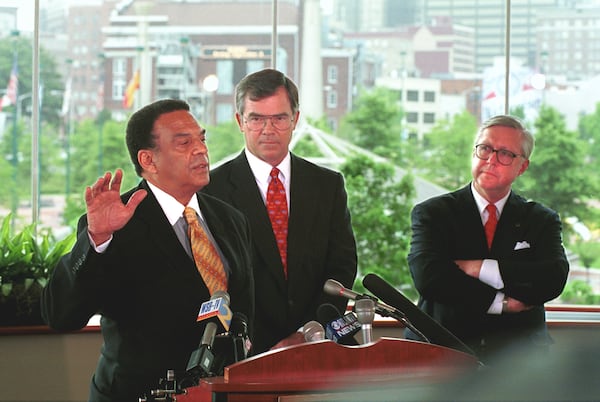 Atlanta Committee for the Olympic Games representatives Billy Payne (middle), A.D. Frazier (right) and Andy Young (left), the trio mainly responsible for bringing the 1996 Summer Games to Atlanta, officially disband the organization on July 1, 1999, in a ceremony overlooking Centennial Olympic Park. (AJC 1999)