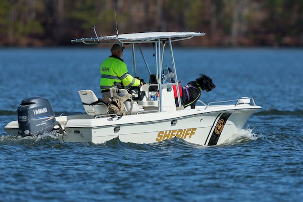 Cyrus, a giant schnauzer, and his handler Kathy Tompkins, of Evans, is taken out on the water by a member of the Putnam County sheriffs to search for Gary Jones on Lake Oconee, Friday, February, 14, 2024, in Eatonton, Ga. The Putnam County sheriff is investigating and searching after Spelman College instructor Joycelyn Nicole Wilson and an Atlanta private school coach Gary Jones went missing on Lake Oconee over the weekend. The body of Wilson was found Sunday and Jones has not been found. (Jason Getz / AJC)