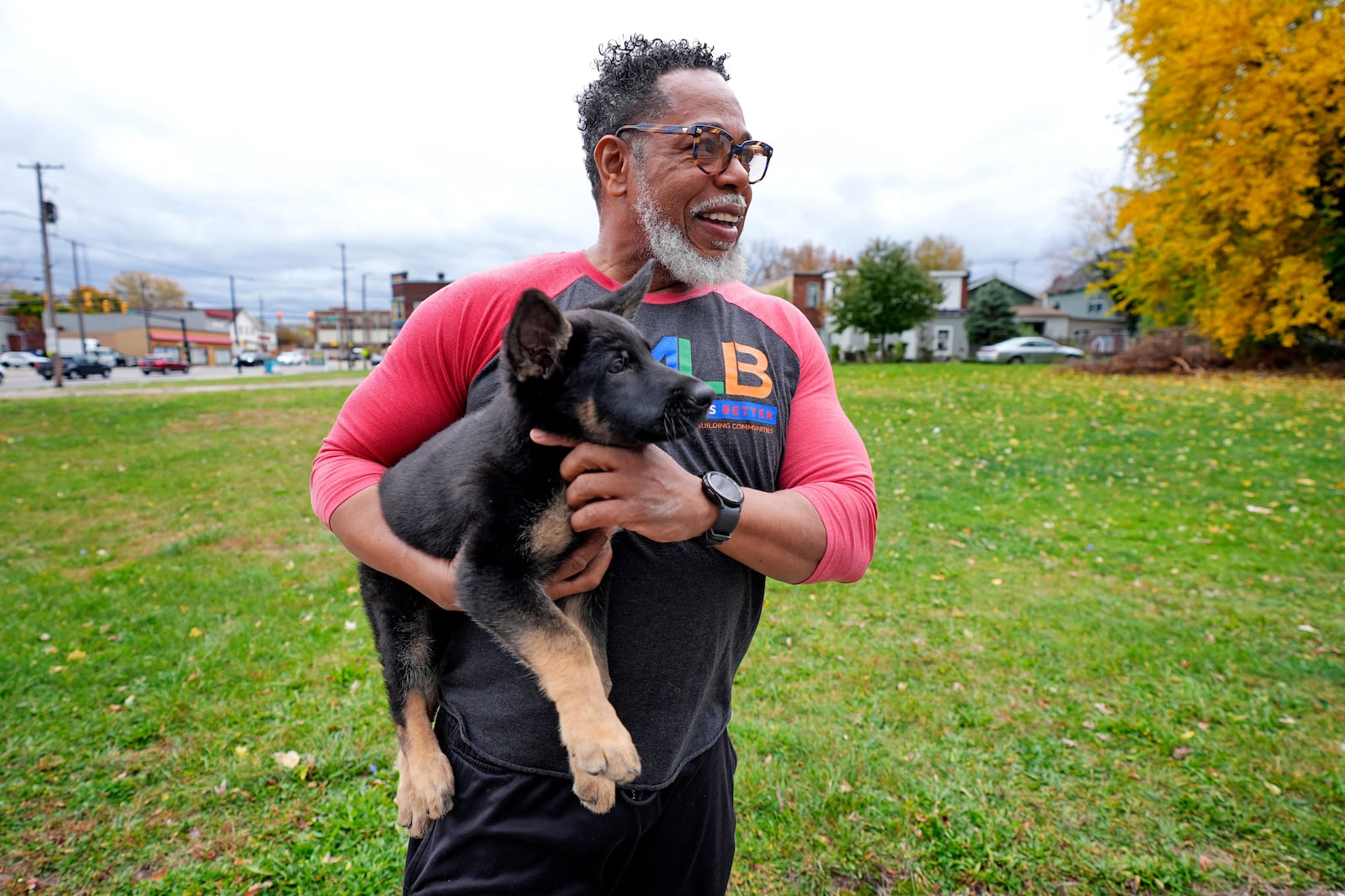 Small business owner Michael Hooks takes a break from working in the kitchen of his catering business to play with his dog in Erie, Pa. Friday, Nov. 1, 2024. (AP Photo/Gene J. Puskar)