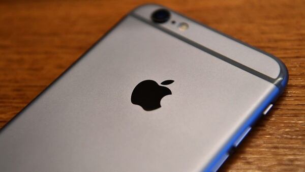 The Apple logo is displayed on the back of an iPhone. Photo by Carl Court/Getty Images.