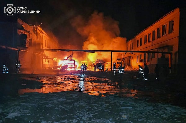 In this photo provided by the Ukrainian Emergency Service, fire engines burn after a Russian drone hit them when firefighters were putting out a fire at a lyceum following Russian drone attack in Bohodukhiv, Kharkiv region, Ukraine, Saturday, March 15, 2025. (Ukrainian Emergency Service via AP)