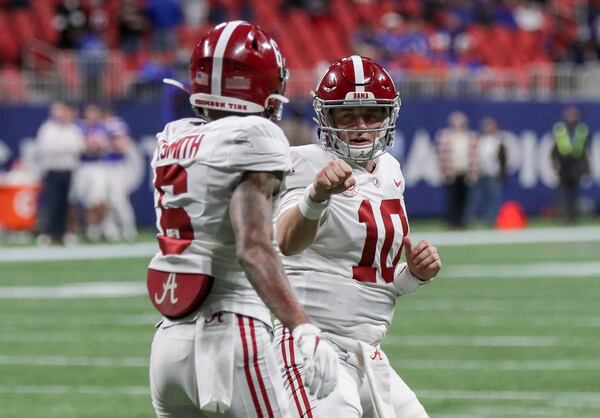 Alabama wide receiver DeVonta Smith (6) gets a fist-bump from quarterback Mac Jones (10) after his first quarter touchdow catch  during the SEC Championship game against Florida Saturday, Dec. 19, 2020 at Mercedes-Benz Stadium in Atlanta. (Curtis Compton / Curtis.Compton@ajc.com)  