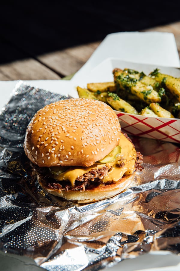 Enjoy Michelin Gourmand-rated food, such as the burger and garlic fries at Fred’s Meat & Bread, that won’t break the bank. Courtesy of Krog District/Brittany Wages