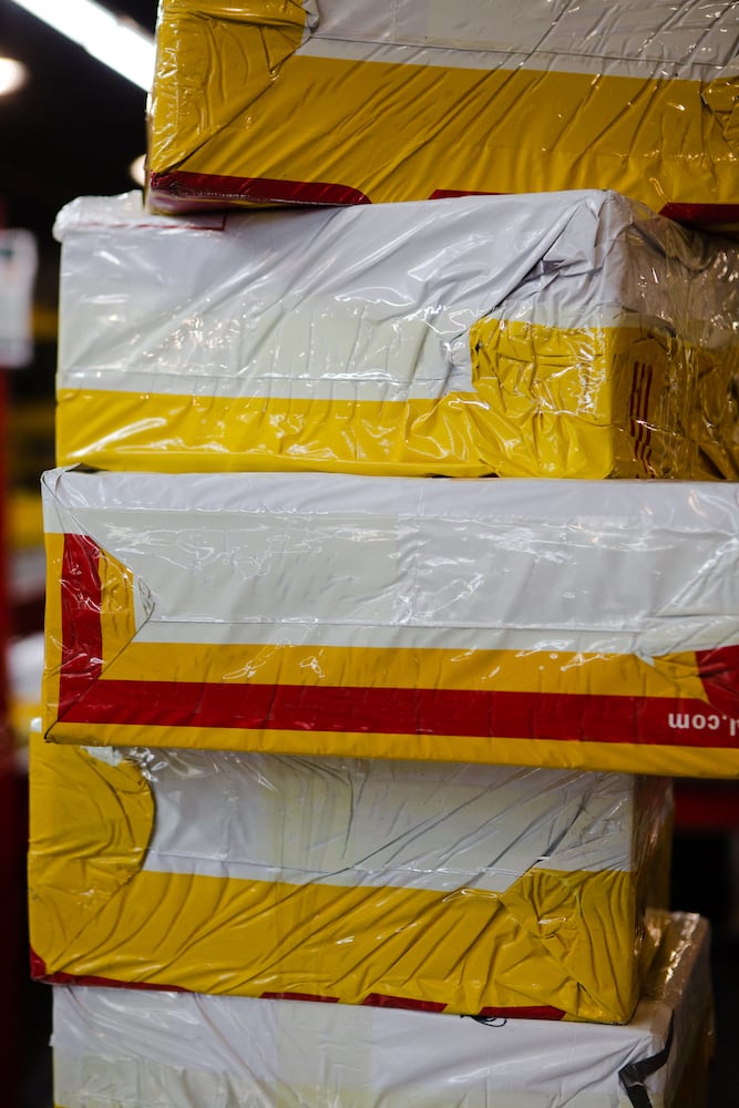 DHL packages are prepared to be shipped on Wednesday, December 16, 2020, at DHL Express in Atlanta. Workers at the shipping center worked to fulfill orders during the holiday rush. CHRISTINA MATACOTTA FOR THE ATLANTA JOURNAL-CONSTITUTION.