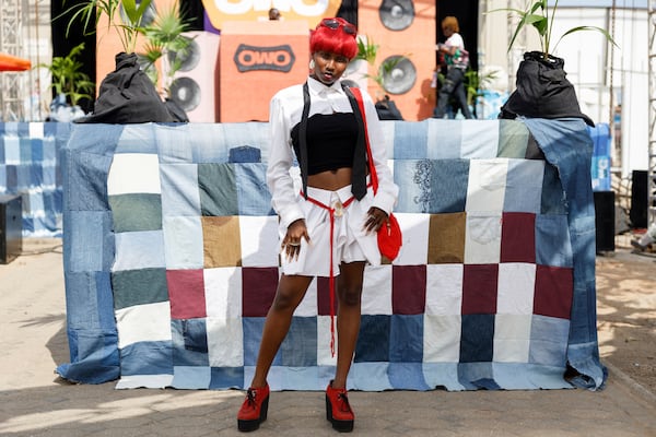 A lady poses for a photograph during a thrift and an upcycle show in Accra, Ghana, Sunday, Oct. 27, 2024. (AP Photo/Misper Apawu)