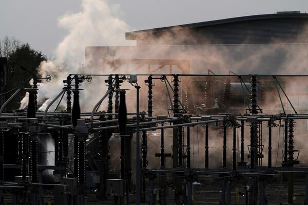 Smoke rises from the North Hyde electrical substation, which caught fire last night, leading to the closure of the Heathrow Airport, in London, Friday March 21, 2025.(AP Photo/Kirsty Wigglesworth)